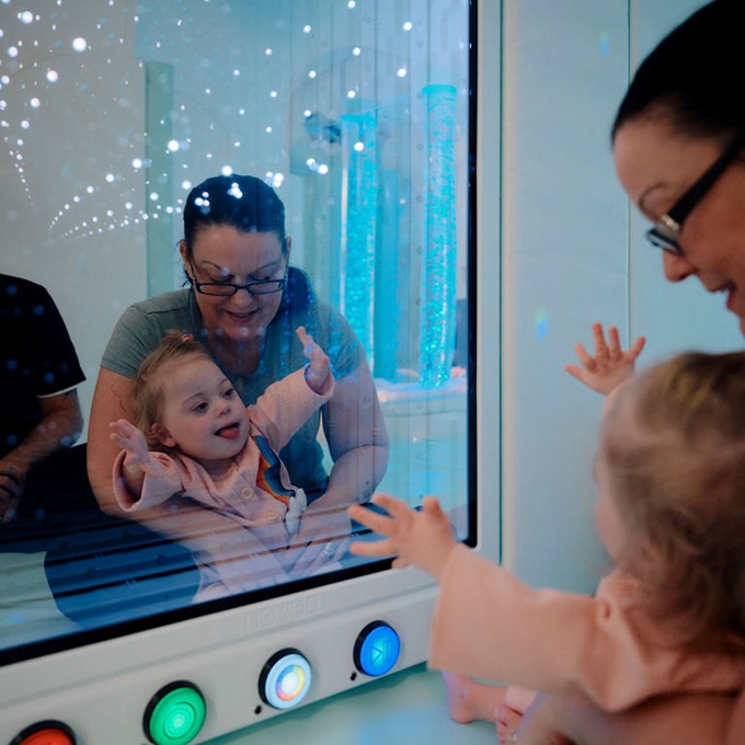 Image of baby and her mother in sensory room at Jersey Hospice Care