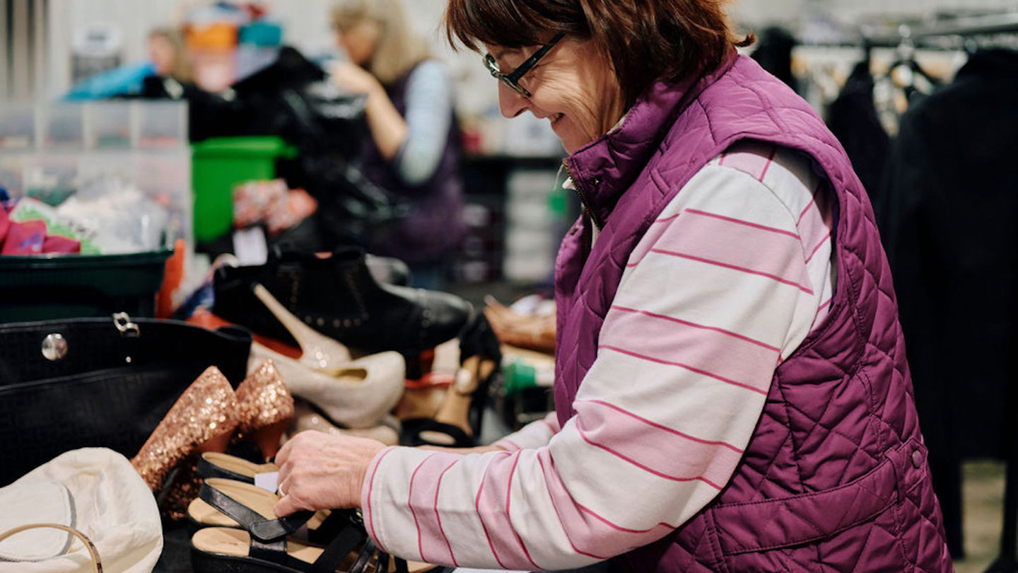 Image of volunteer sorting clothes