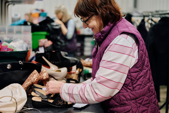 Image of volunteer sorting clothes