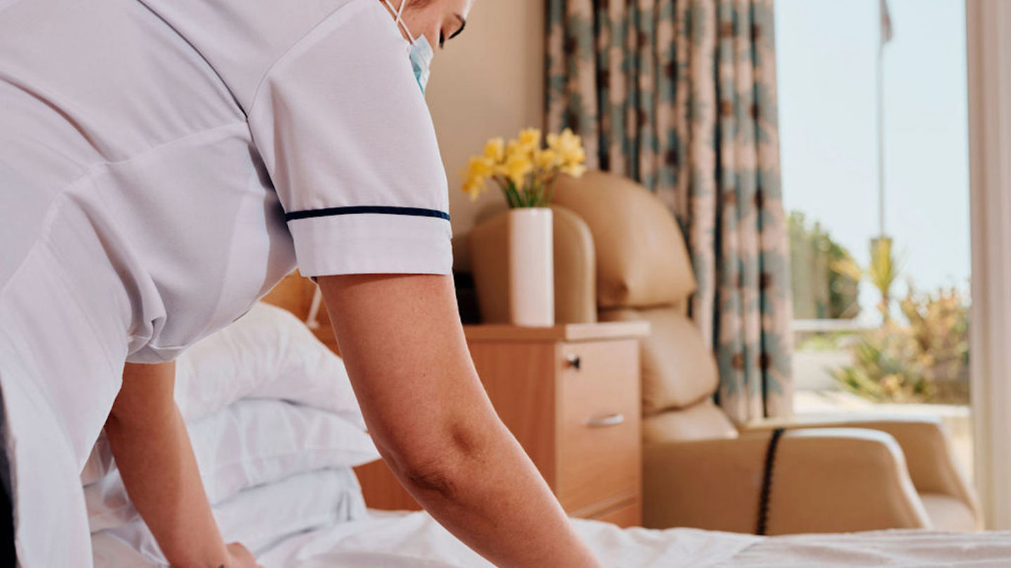 Image of nurse making a bed in room at Jersey Hospice Care In Patient Unit