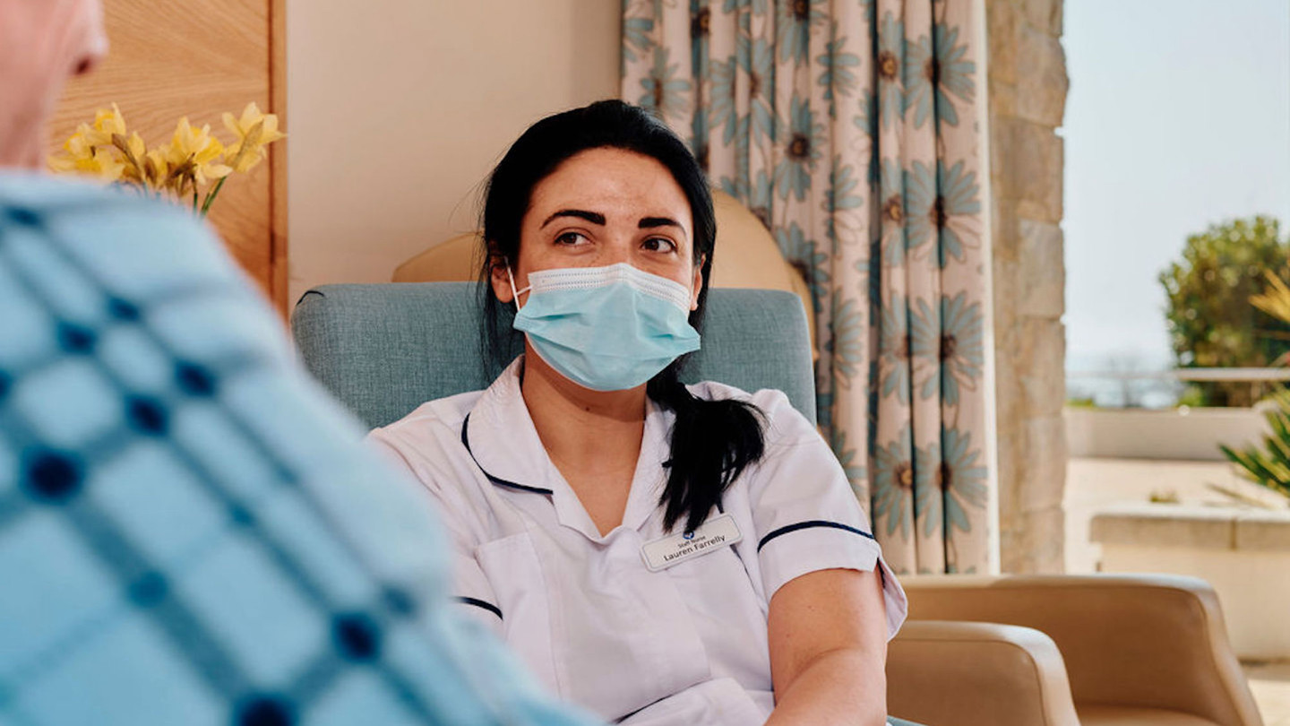 Image of nurse looking at patient