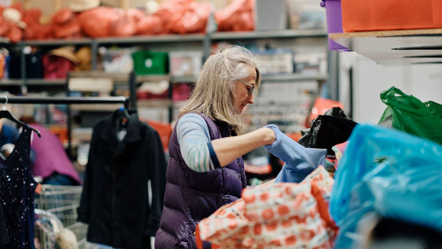 Image of Hospice volunteer sorting clothes