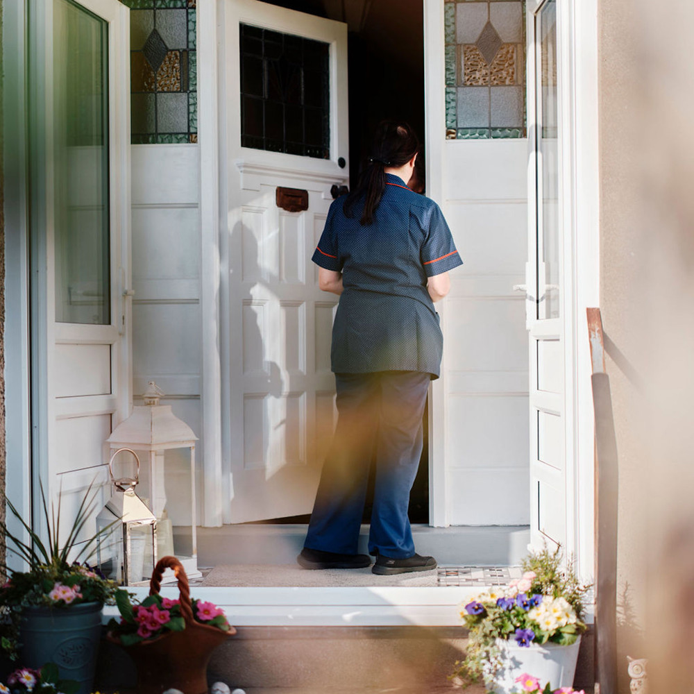 Image of community team nurse knocking on patients door