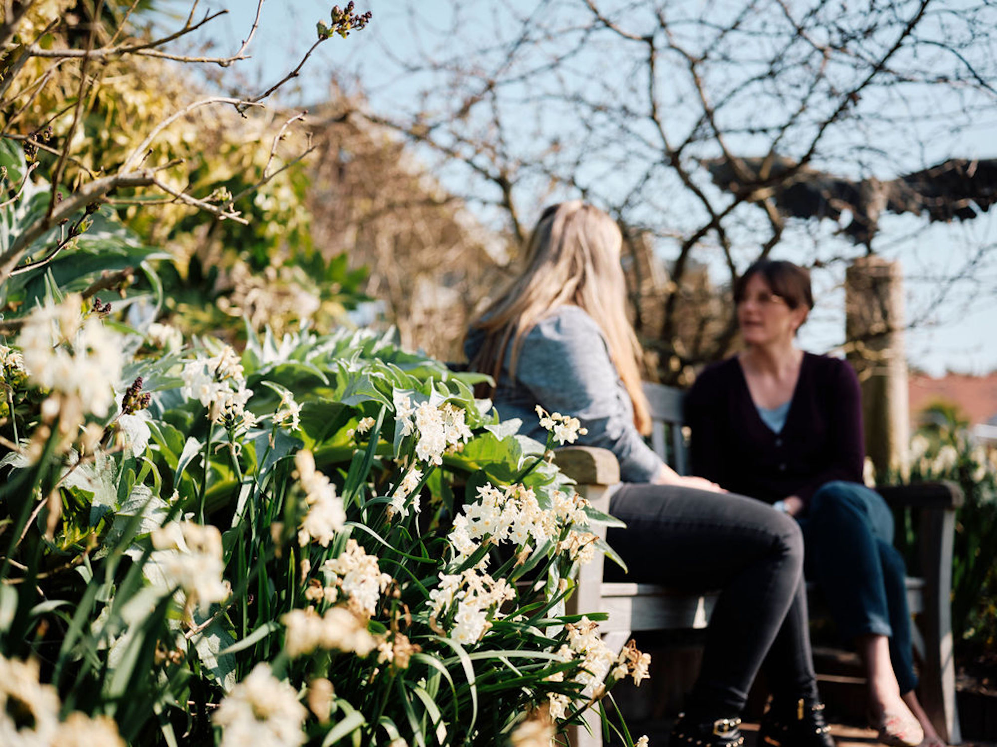 Image of Rev Emily in the gardens talking to patient 