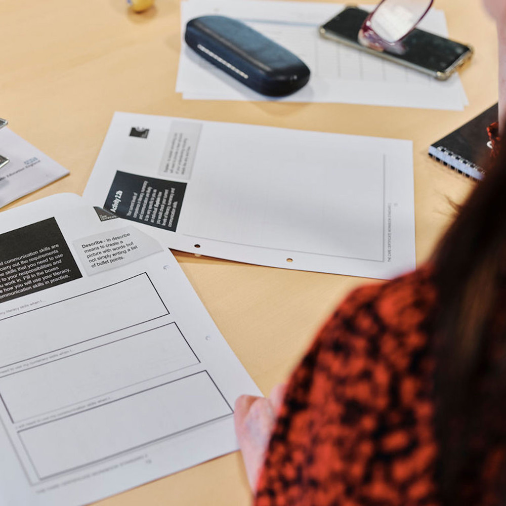 Image of woman taking notes in education course