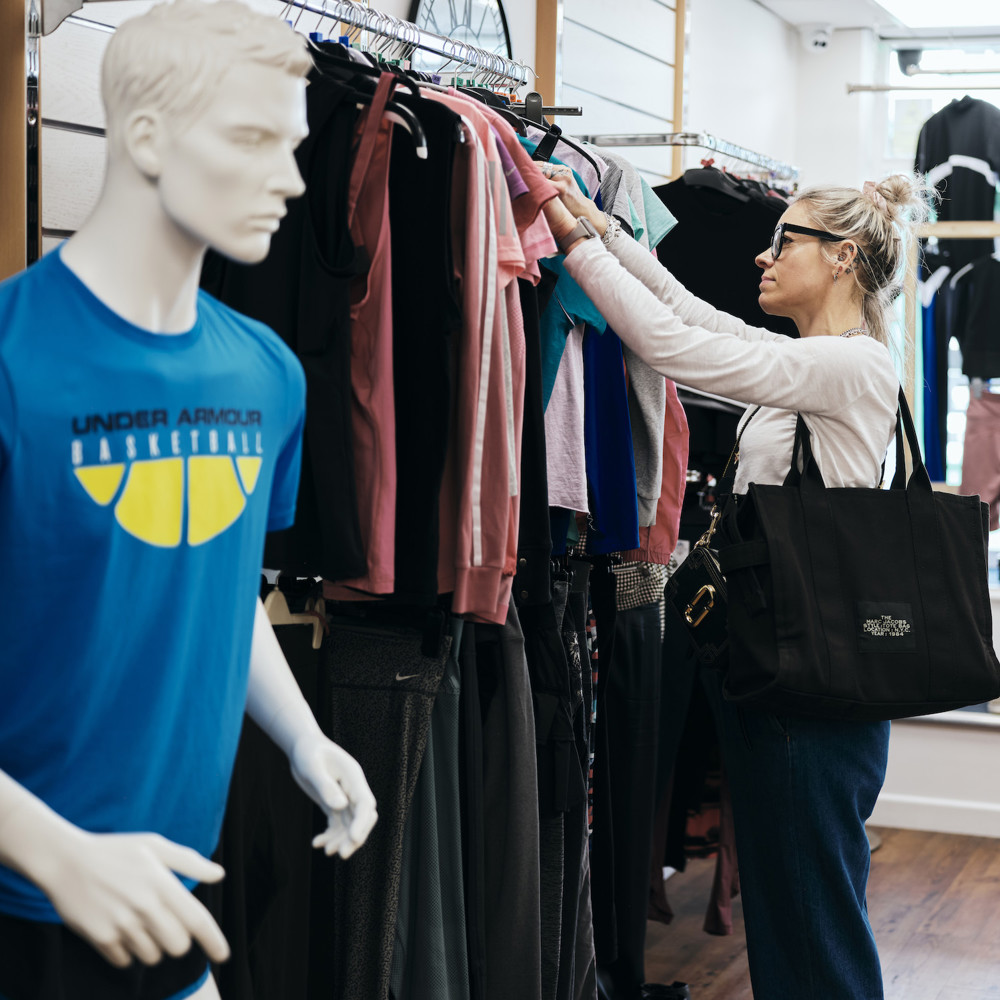 Image of customer browsing clothes in st helier fundraising store