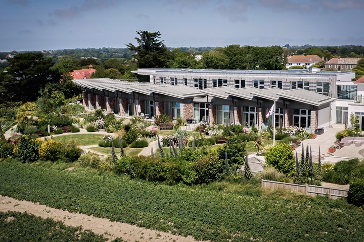 image of aerial view of Jersey Hospice care building and gardens from nearby field 
