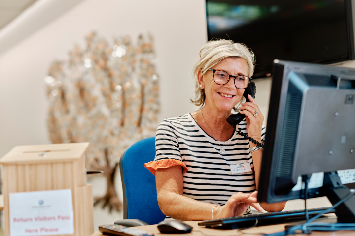 Image of volunteer on reception at jersey hospice care