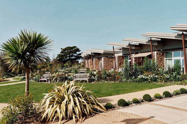 Image of hospice gardens with in patient unit in the background 