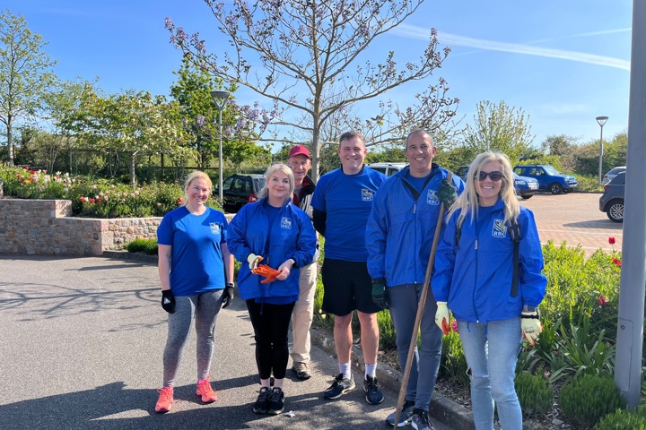 Image of a group volunteers from RBC with gardening equipment