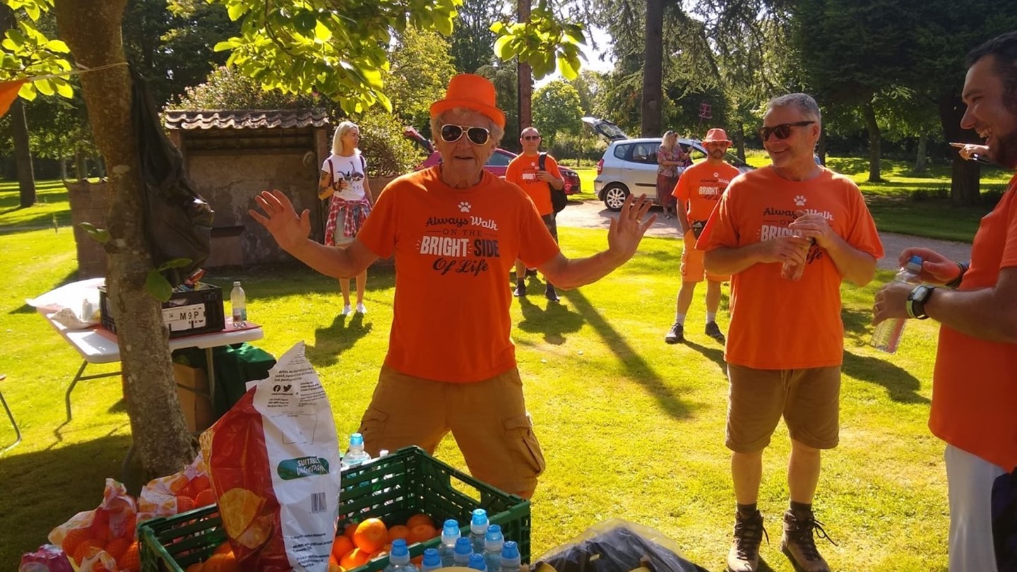 Image of man in Orange t-shirt at event