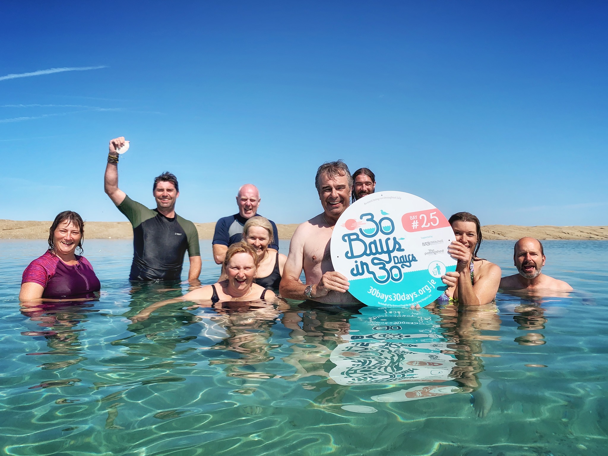 Image of swimmers in the sea with 30 Bays in 30 Days sign