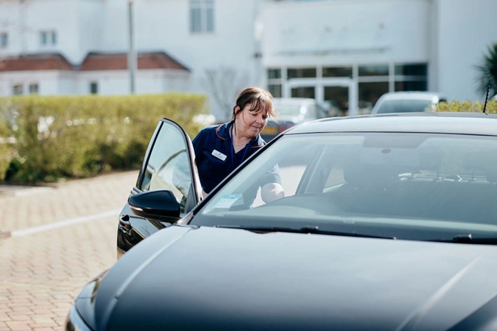 Image of nurse getting into her car 