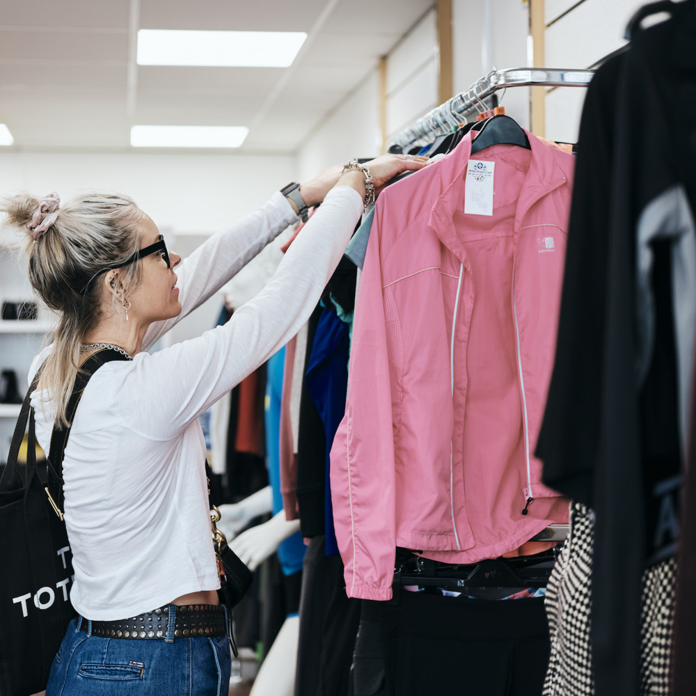 Image of customer brousing clothes in st helier fundraising store