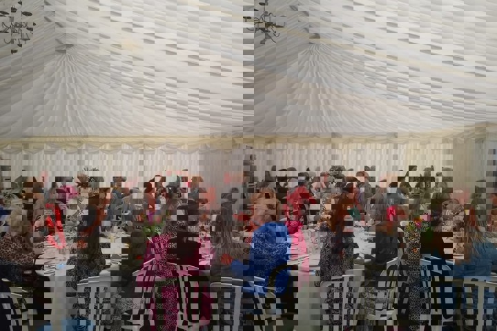 Image of ladies in marquee eating lunch