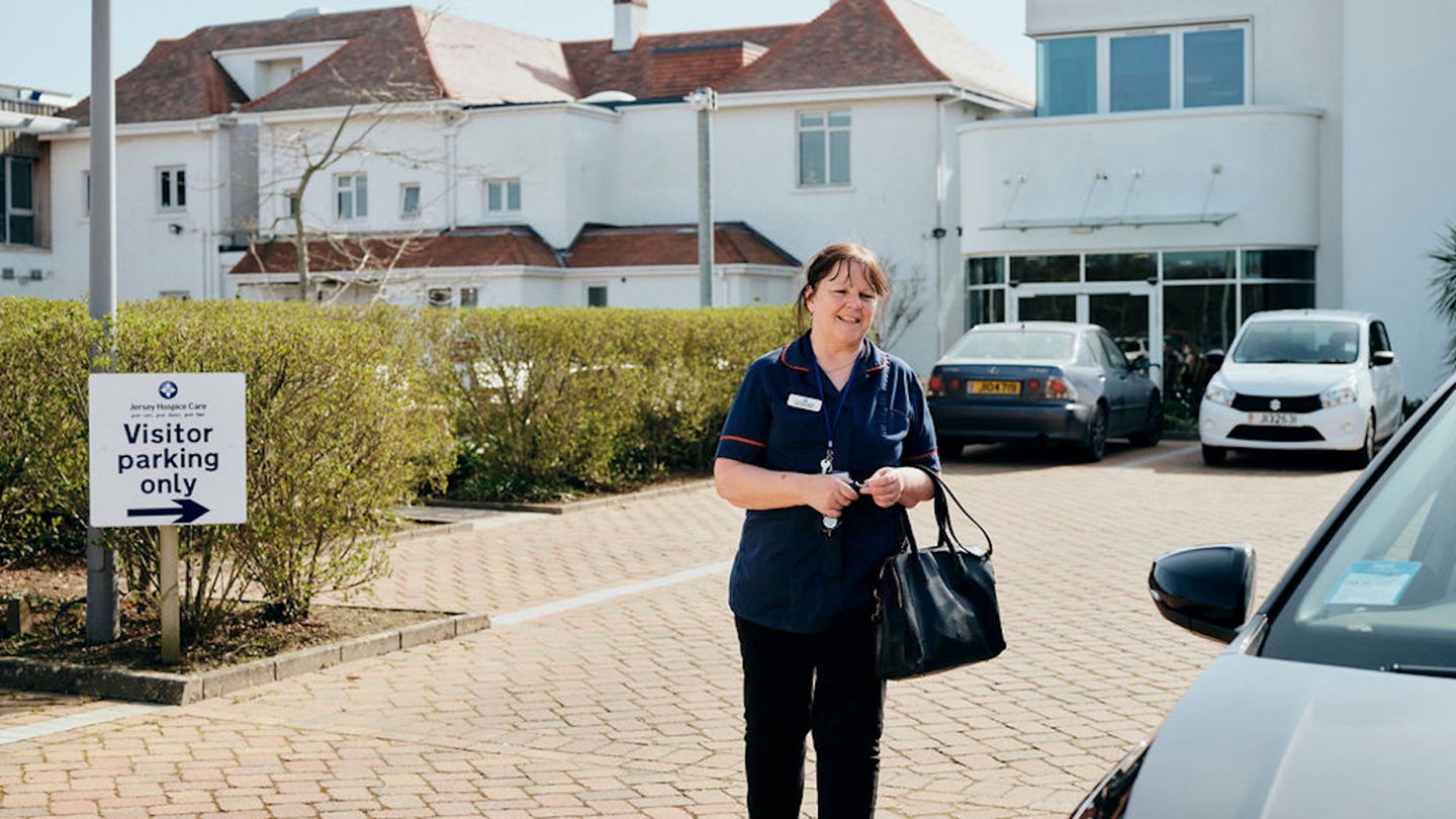 Image of community team nurse walking in car park at Jersey Hospice Care