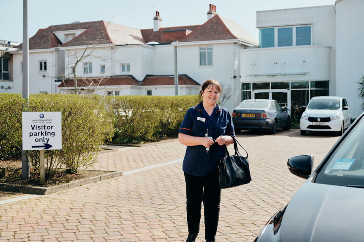 Image of community team nurse walking in car park at Jersey Hospice Care