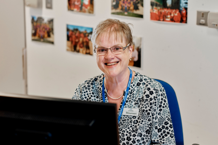 Image of admin volunteer at a computer  at jersey hospice care