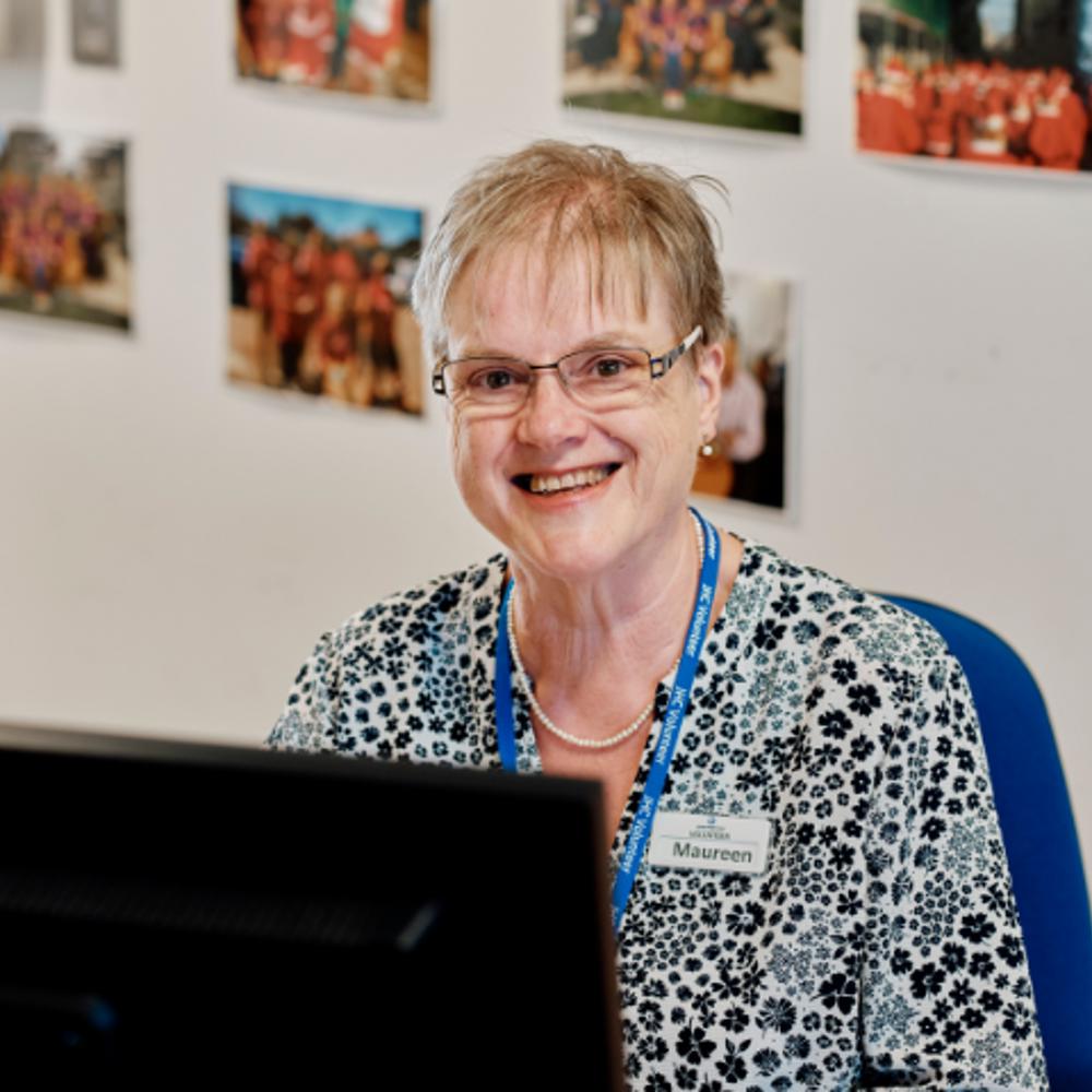 Image of admin volunteer at a computer  at jersey hospice care