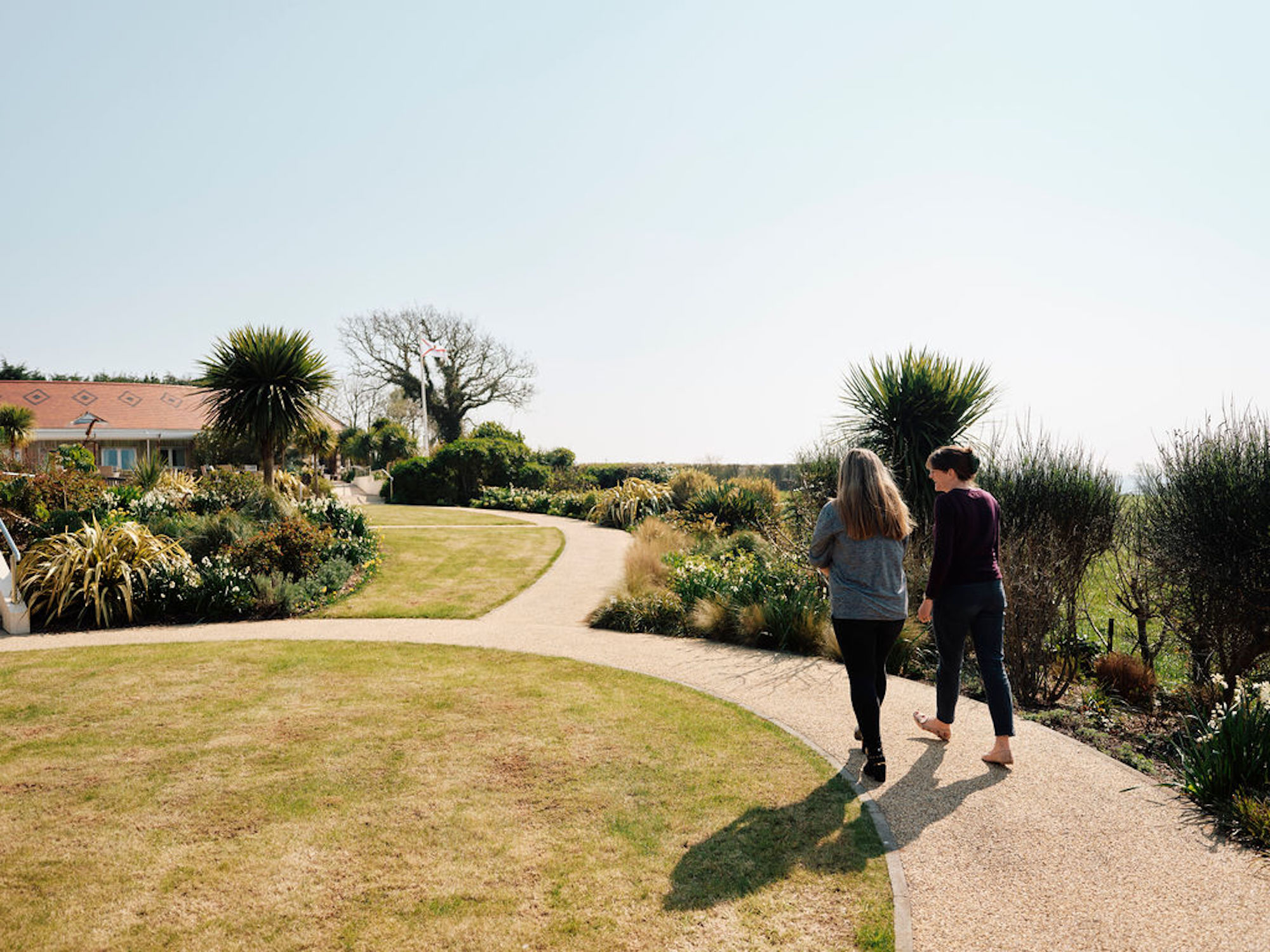 Image of Rev Emily in the gardens talking to patient 